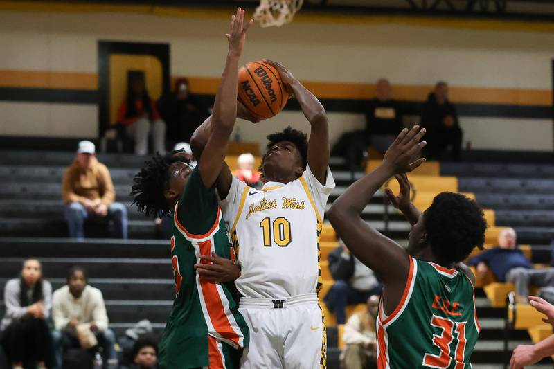 Joliet West’s Abrey Robinson takes the contested shot against Plainfield East on Friday, Dec. 19, 2025 in Joliet.