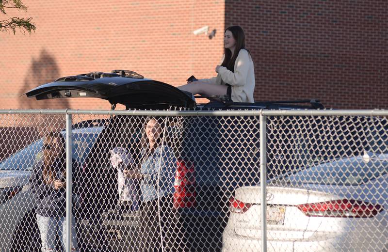 Eleanor Forsythe of Western Springs finds a creative way to watch graduates during the Lyons Township graduation  Wednesday May 29, 2024.