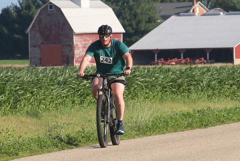 A cyclist rides past a barn along 2250 East Street during the Z Tour event on Saturday June 21, 2025 in Princeton. Z Tour is an annual charity event supports the Zearing Child Enrichment Center, a not-for-profit organization. The event offers various paved road routes, including 10, 30, 65 mile loops. Riders begin and end at Zearing Park.