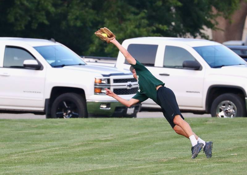 St. Matthew's center fielder Reid Clary makes a circus catch during Monday's Princeton Fastpitch Church League play at Westside Park. St. Matts, the defending league champion, led 8-2, but fell to United Methodist 16-8. UMC advances to Thursday's finals.