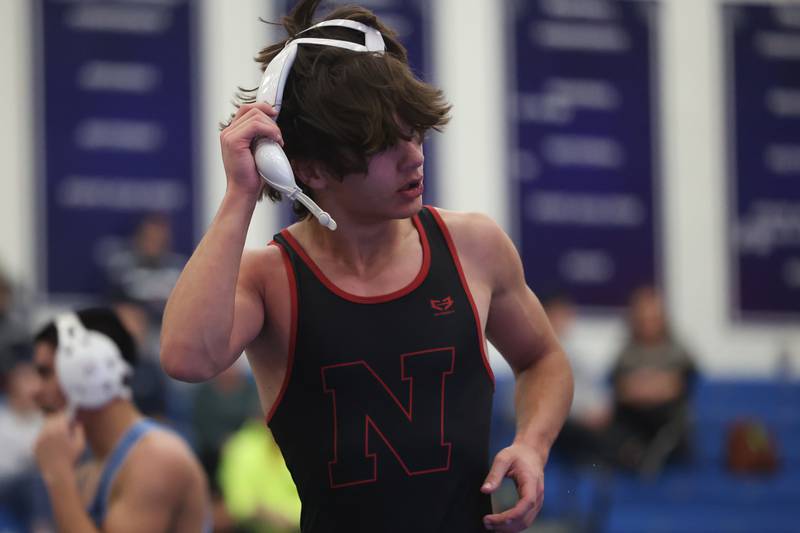 Plainfield North’s Lucas Frydrychowski removes his headgear after a win against Plainfield South’s Damien Angniano in a Southwest Prairie dual meet on Wednesday, Nov. 29, 2023 in Plainfield.