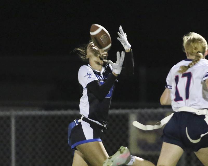 St. Charles North's Jillian Salter (30) hauls in a catch near the sidelines during Oswego East Regional Final flag football game between St. Charles North at Oswego East Thursday, Oct 9, 2025 in Oswego.