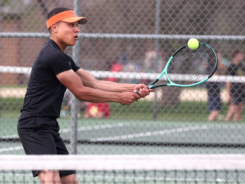 DeKalb number one singles player Atah Shakir hits a backhand Thursday, April 24, 2025, during their match at Sycamore High School.