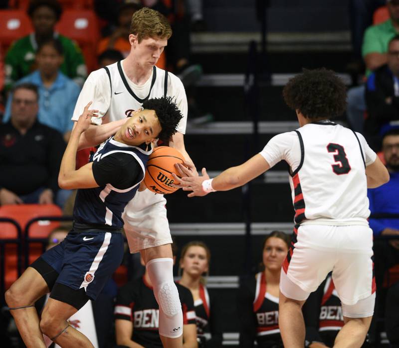 Evanston's Kaidan Chatham runs into Benet Academy's Colin Stack after getting foulded by Jayden Wright, right, during the IHSA Class 4A boys basketball state semifinals at State Farm Center on Friday, March 14, 2025 in Champaign.