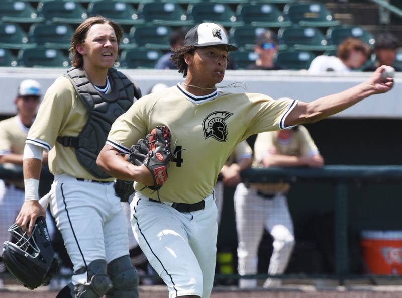 Sycamore relief pitcher Tommy Townsend throws to first after fielding a soft infield grounder as catcher Kyle Hartmann stands behind him during the Class 3A state baseball semifinal in Joliet on Friday.