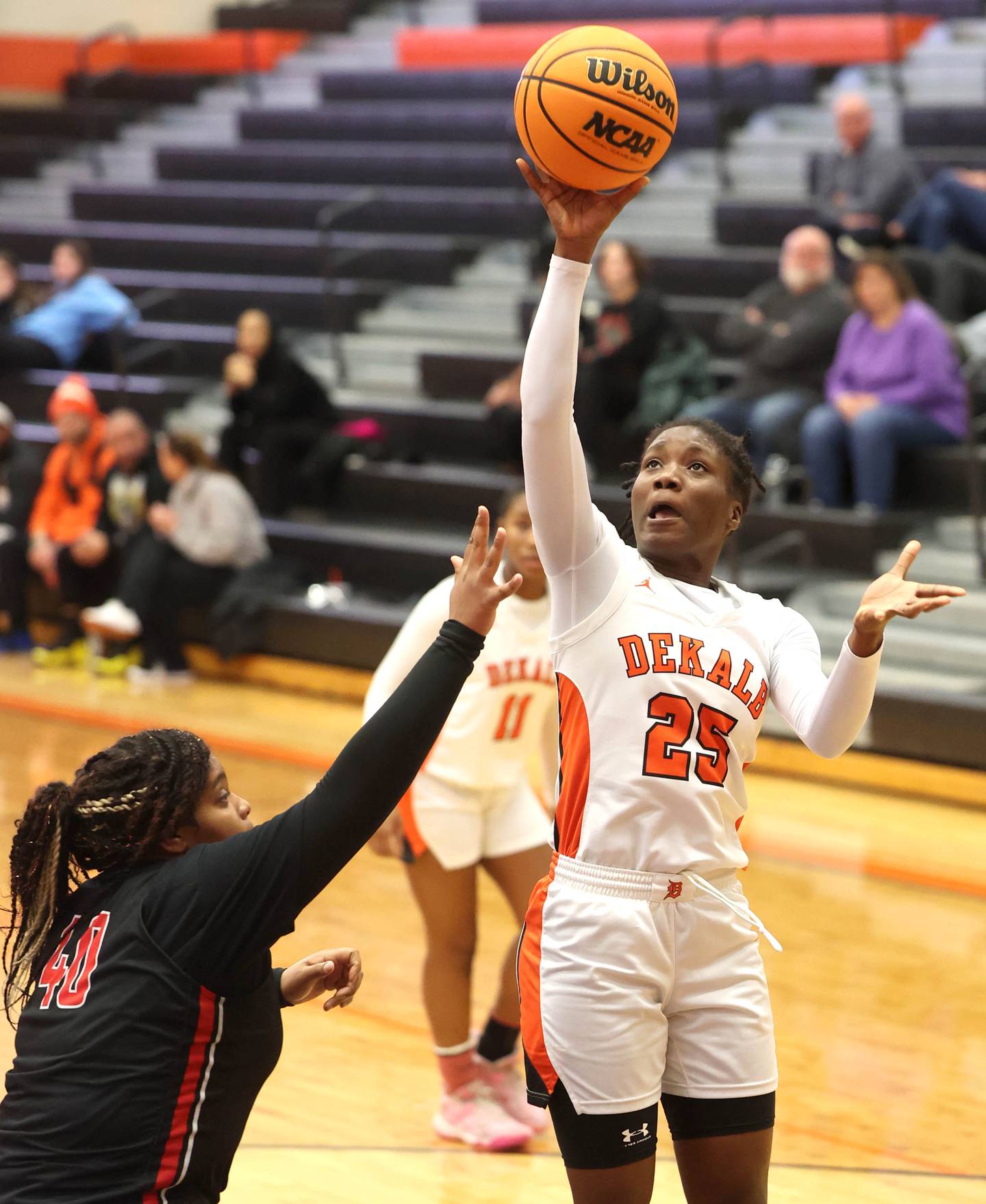 DeKalb's Kezaria Mitchell shoots over Rockford East's Makya Knox during their game Wednesday, Jan. 22, 2025, at DeKalb High School.