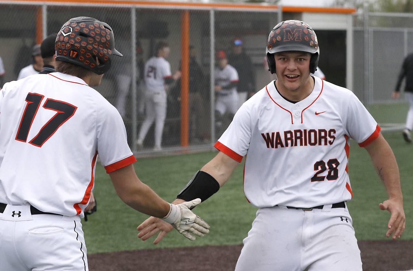 McHenry’s Connor McLean (right) celebrates scoring the game tying run with teammates, \Donovan Christman, during a Fox Valley Conference baseball game against Crystal Lake Central  on Friday, May 2, 2025, at McHenry High School.
