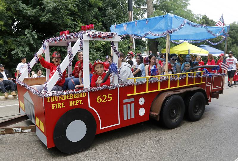 Thunderbird Preschool students ride in a fire truck float Sunday, July 2, 2023 during Crystal Lake’s annual Independence Day Parade on Dole Avenue in Crystal Lake. This year’s parade feature close to 100 units.