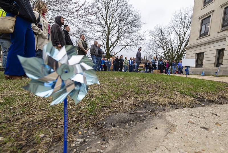 Blue pinwheels are set up on the lawn of the Old Lee County Courthouse Friday, April 10, 2026, to help raise awareness of child abuse.