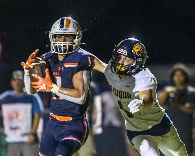 Oswego's Teddy Manikas (11) makes a catch that resulted in a touchdown during a football game between Neuqua Valley and Oswego on Friday, Aug. 30, 2024 in Oswego. Gary E Duncan Sr for Shaw Local News Network.