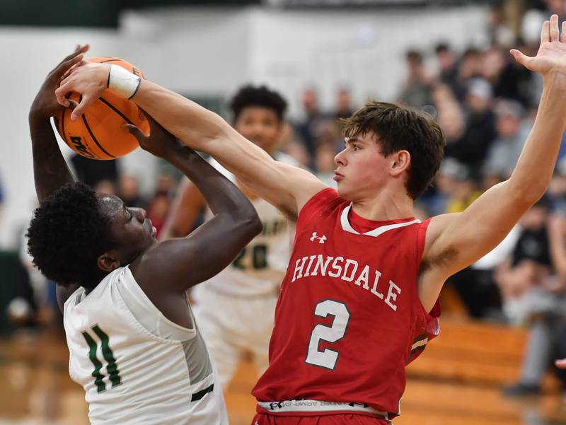 Hinsdale Central’s Dillon Orozco (2) ties up Glenbard West’s Teyion Oriental (11) during a game on January 31, 2025 at Glenbard West High School in Glen Ellyn.