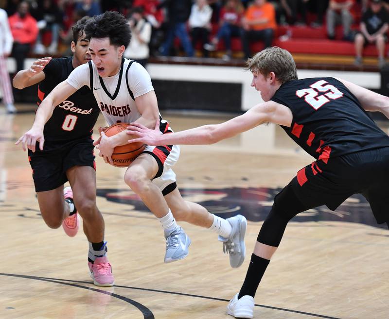 Bolingbrook's Josh Aniceto drives between Benet's Blake Fagbemi and Gabe Sularski during a Class 4A East Aurora Sectional semifinal game on Feb. 27, 2024 at East Aurora High School in Aurora.