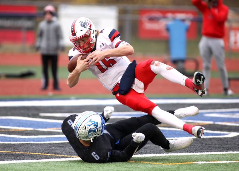 St. Rita's Jett Hilding (16) gets into the endzone over St. Charles North's Drew Surges (6) for a 2-point conversion in the second half during their 7A quarterfinal game in St. Charles on Saturday, Nov. 12, 2022.