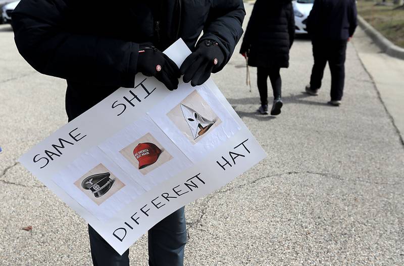 A protester holds a sign near the intersection of McCullom Lake Road and State Route 31,  on Saturday, March 28, 2026, during the McHenry County No Kings Protest. According to an organizer, over 4,000, people took part in the protest.