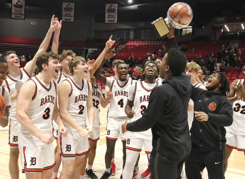 DeKalb players receive the trophy and celebrate their win over Sycamore Friday, Jan. 26, 2024, during the FNBO Challenge in the Convocation Center at Northern Illinois University.