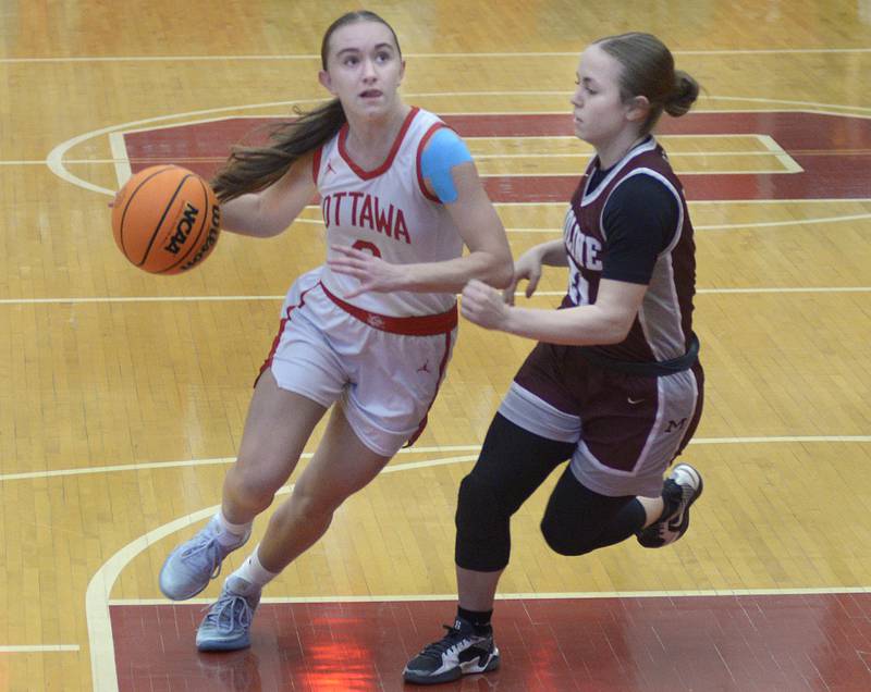 Ottawa’s Ashlynn Ganiere drives to the basket past Moline’s Bridget Machado in the 1st period Tuesday at Ottawa.