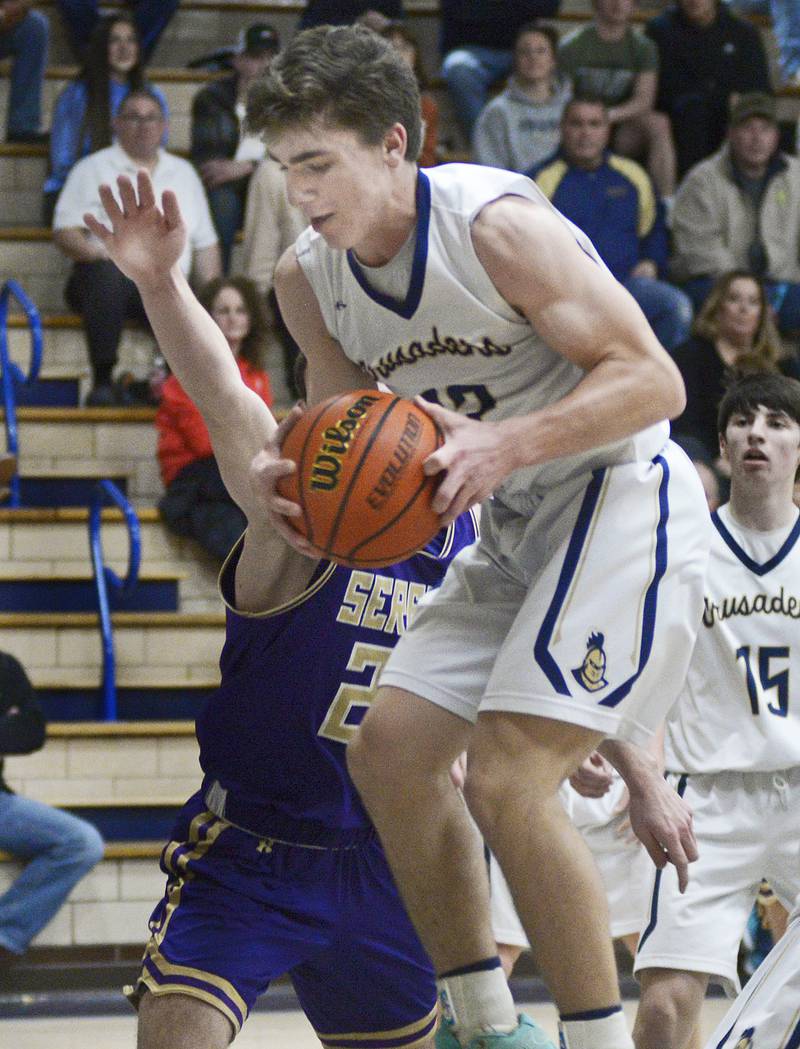 Marquette’s Denver Trainor pulls this rebound ahead of Serena’s Richie Amour during the 1st period Tuesday at Marquette.