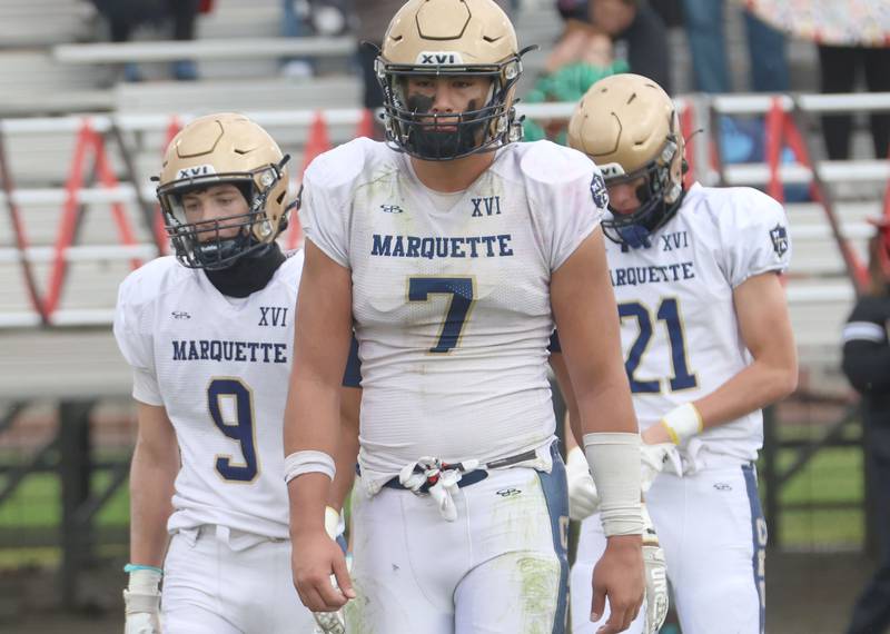 Marquette players Easton Debernardi, Blayden Cassel and Lucas Craig walk off the field after being defeated during the Class 1A playoff game on Saturday, Nov. 1, 2025 at Gibson City-Melvin-Sibley High School.