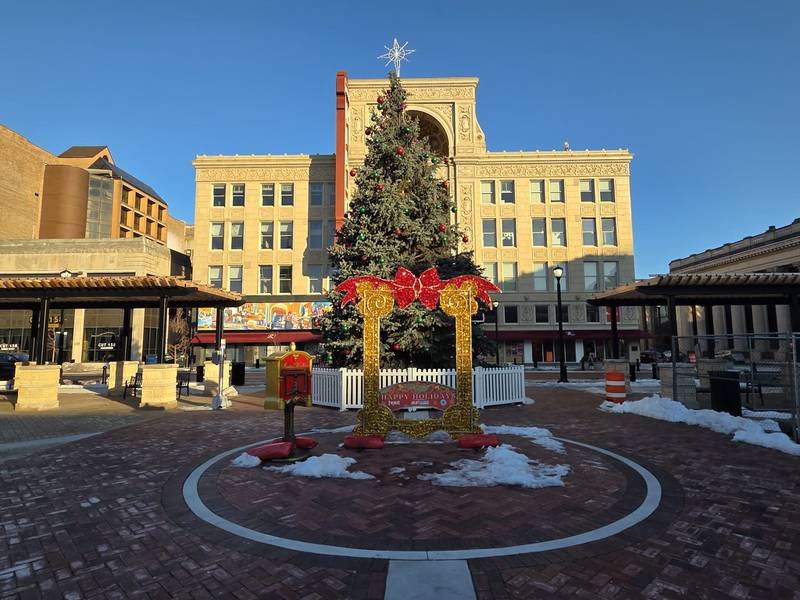 The Christmas tree in downtown Joliet's new city square with the Rialto Square Theatre in the background is seen on Tuesday, December 16, 2025.