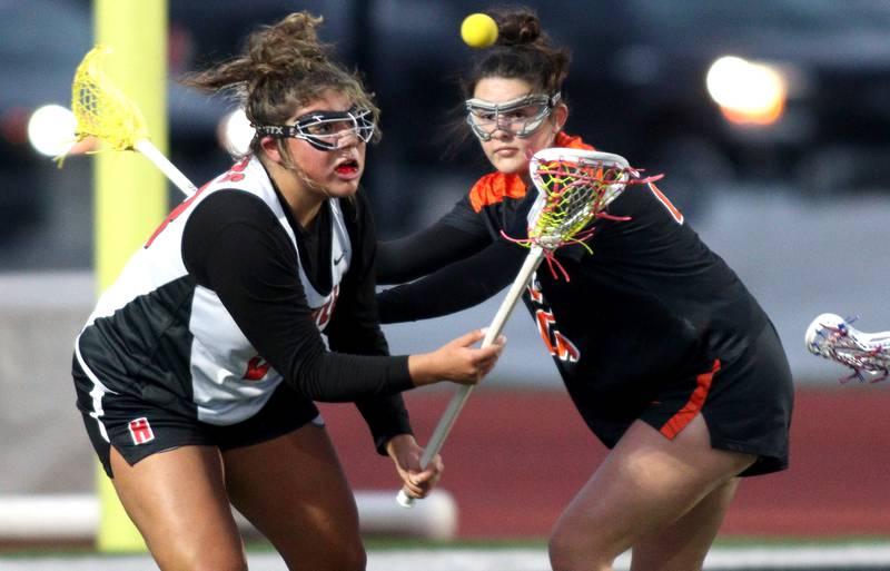 Huntley’s Payton Turczyniak, left, and Crystal Lake Central’s Colleen Dunlea look for control of the ball in varsity lacrosse at Huntley Wednesday.