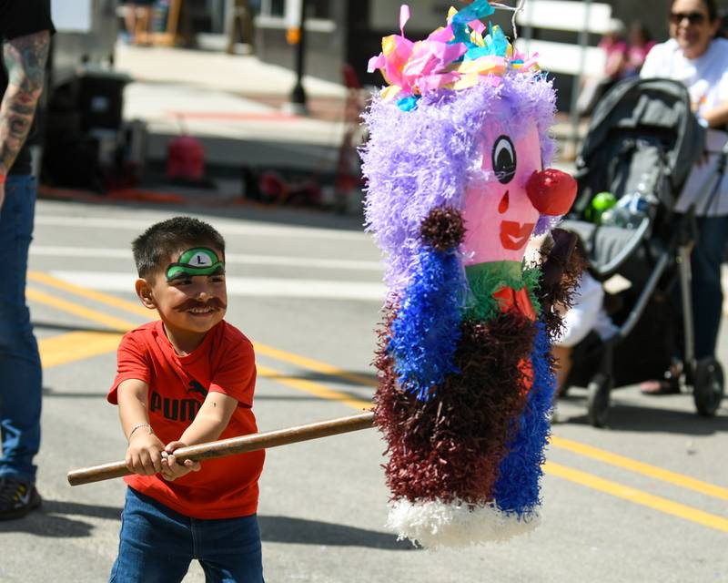 Gael Arnulf, 3, of DeKalb, has a go at breaking the piñata during the second annual Cinco de Mayo Celebration in downtown DeKalb on Sunday, May 5, 2024.
