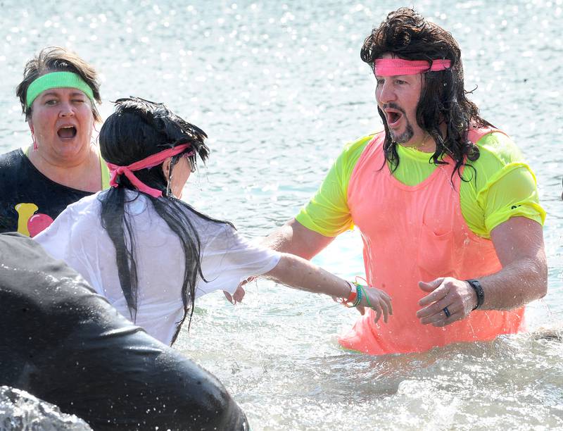 Kendall County Undersheriff Bobby Richardson and his son Austine celebrate their plunge during the annual Polar Plunge to support Special Olympics Illinois at Siver Springs State Park's Loon Lake on Sunday, Mar. 5, 2023.