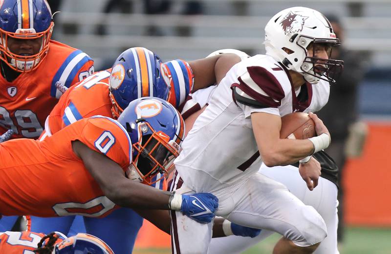 Prairie Ridge's Tyler Vasey tries to pull away from East St. Louis' Antwon Hayden during their IHSA Class 6A state championship game Saturday, Nov. 26, 2022, in Memorial Stadium at the University of Illinois in Champaign.
