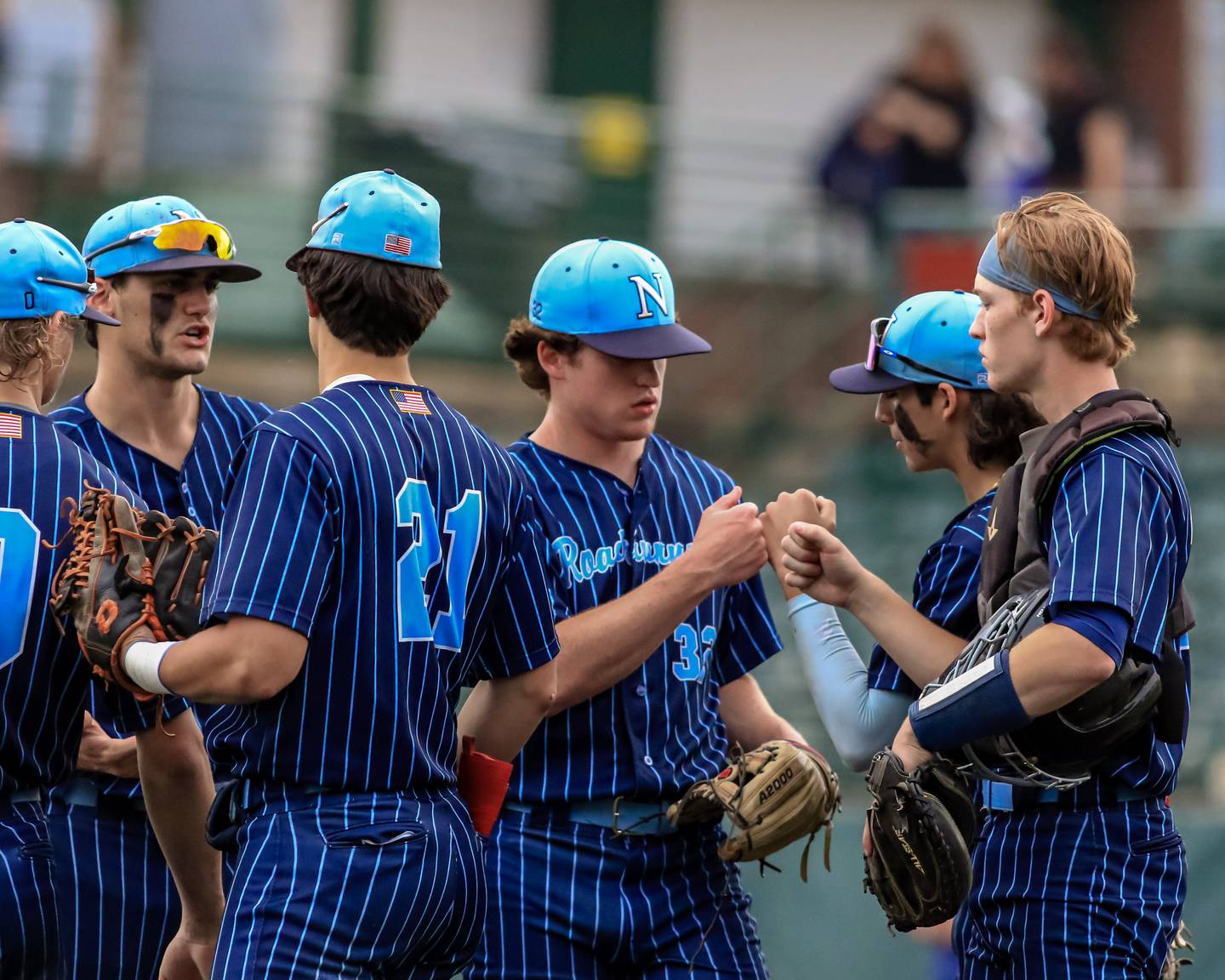 Nazareth's Finn O 'Meara (32) gets encouragement on the mound from his teammates during the Class 3A Crestwood Supersectional game between St. Ignatius at Nazareth.  June 6, 2022.