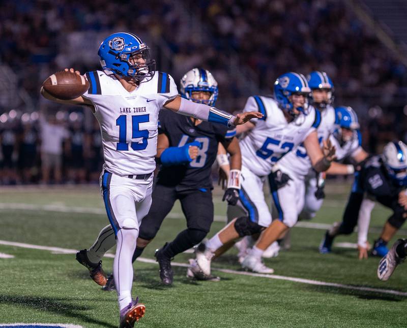 Lake Zurich's Ashton Gondeck (15) looks to pass the ball down field against St. Charles North during a football game at St. Charles North High School on Friday, Sep 2, 2022.