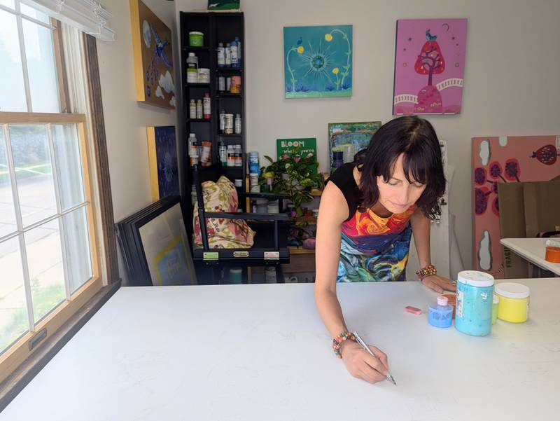 Aurora artist Laura Lynne sketching the outline for a paint-by-number mural project for the Geneva Chamber of Commerce. Volunteers will be painting it on Friday and Saturday, July 25 and 26.