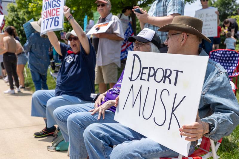 Protester holds sign at the “No Kings” protest on Saturday, June 14, 2025 at Rotary Park in Princeton.