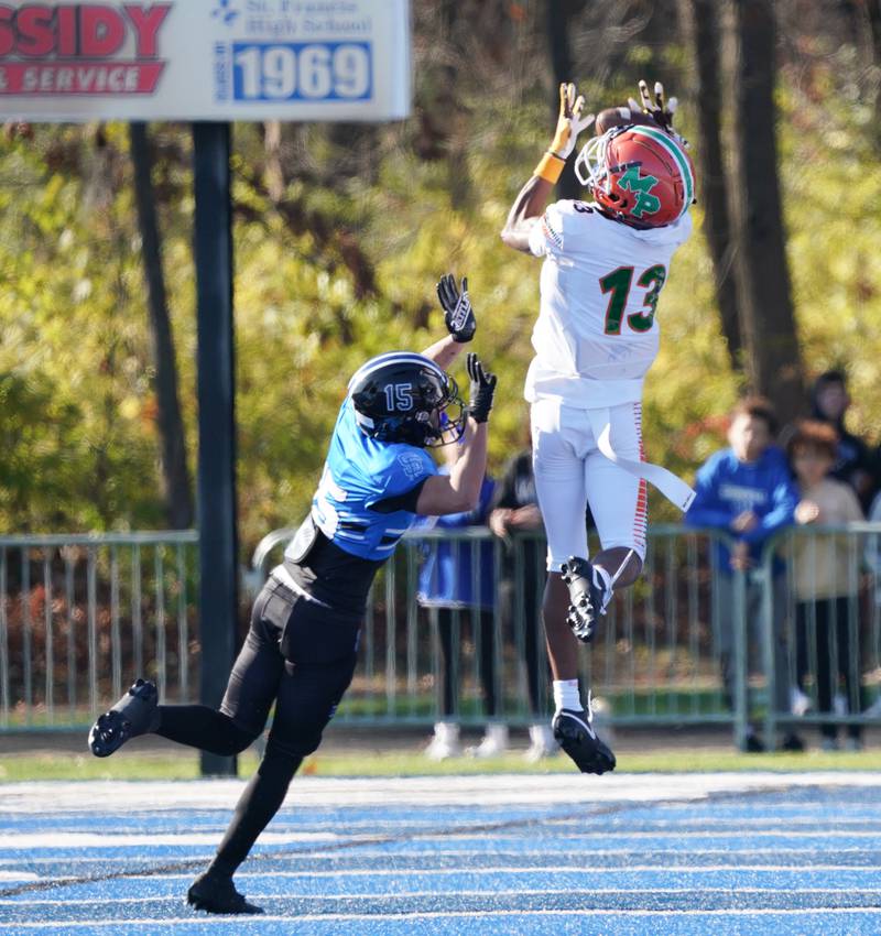 Morgan Park's Chris Durr (13) leaps up for the reception against St. Francis' Asher Boose (15) during a class 5A state quarterfinal football game at St. Francis High School in Wheaton on Saturday, Nov 11, 2023.