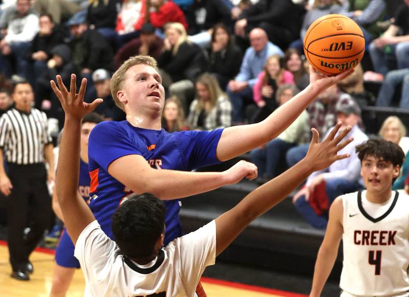 Genoa-Kingston's Hayden Hodgson goes to the basket against Indian Creek's Faustino Mora during their game Friday, Jan. 3, 2025, at Indian Creek High School in Shabbona.