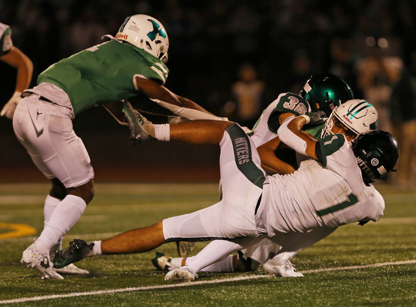 York's Matt Vezza (9) is tackled by Glenbard West's Michael Short (1) during the boys varsity football game between York and Glenbard West on Friday, Sept. 30, 2022 in Elmhurst, IL.