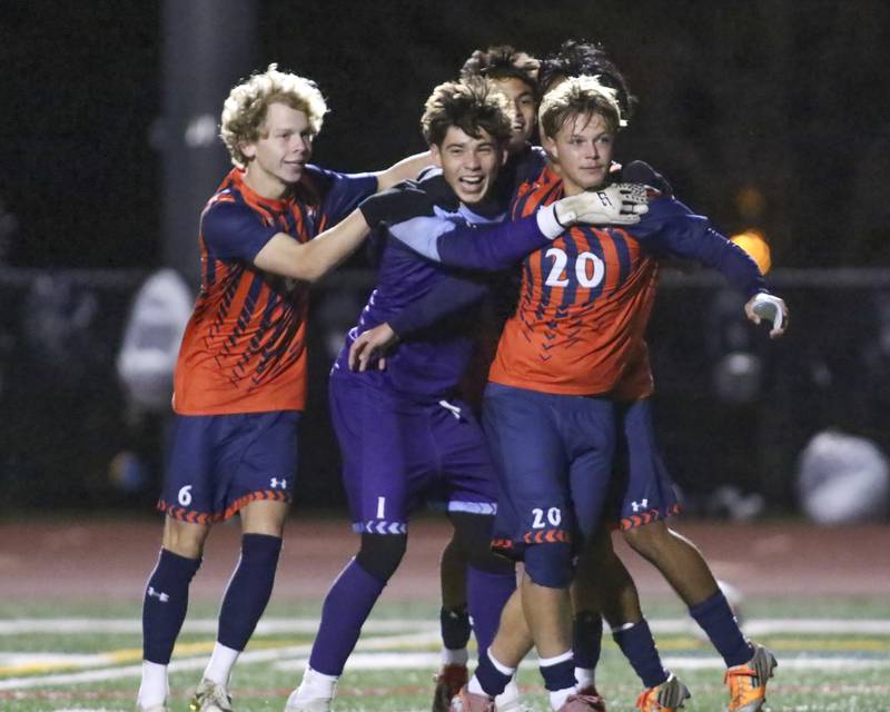 Oswego's Christian Lopez (1) celebrates with his teammates after winning their Class 3A Naperville Central Regional semifinal soccer match between Plainfield North at Oswego, Tuesday Oct 21, 2025.
