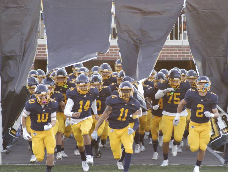 The Sterling High School  Football team runs onto the field before their game Friday night . The Lions of Urban Prep traveled to Sterling to take on the Warriors at Prescott Memorial Field at Roscoe Eades Stadium, September 5, 2025.