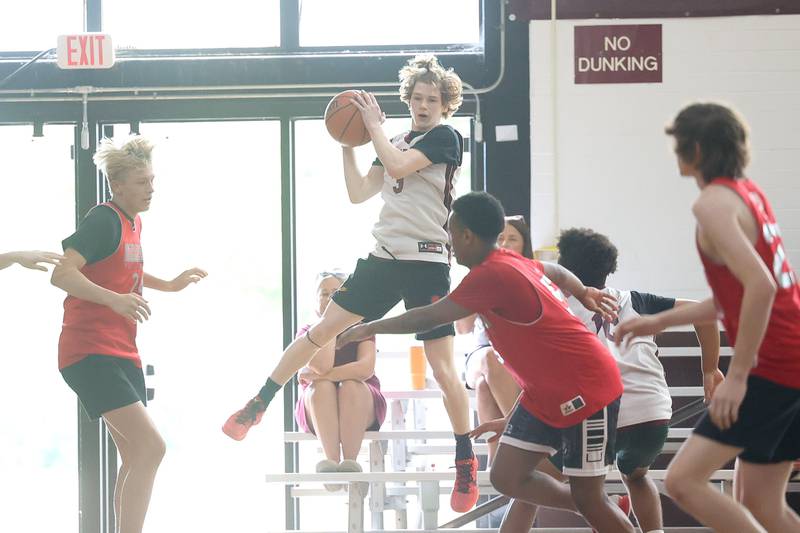 A Plainfield North player pulls in a rebound against Streator at the 37th Morris Boys Shootout on Tuesday, June 25, 2024.