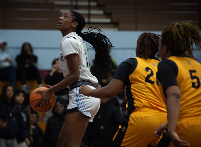 Kankakee's Shania Johnson looks for a shot under the net in a game against Thornwood on Thursday, December 11, 2025.