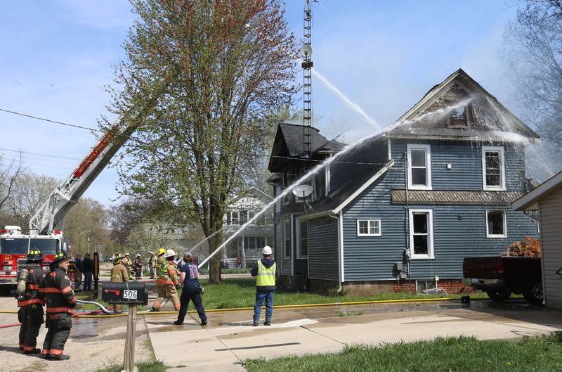 Firefighters from Paw Paw, Somonauk, Troy Grove, Mendota, Earlville, Leland, Utica and Ottawa work the scene of a house fire in the 300 block of Maple Street on Monday, April 22, 2024 in Earlville. The fire happened around 10a.m.