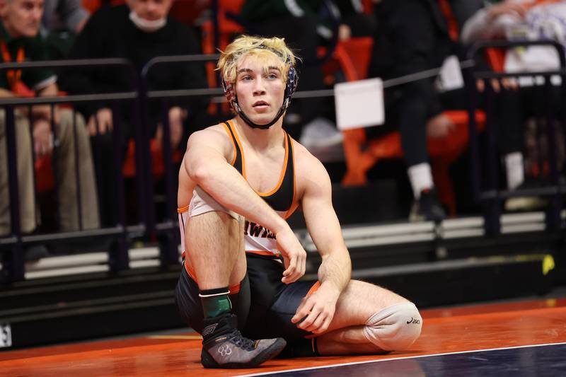 Sandwich’s Aidan Linden sits on the mat during a timeout against Stillman’s Jack Seacrist in the Class 1A 152lb. semifinals at State Farm Center in Champaign. Friday, Feb. 18, 2022, in Champaign.