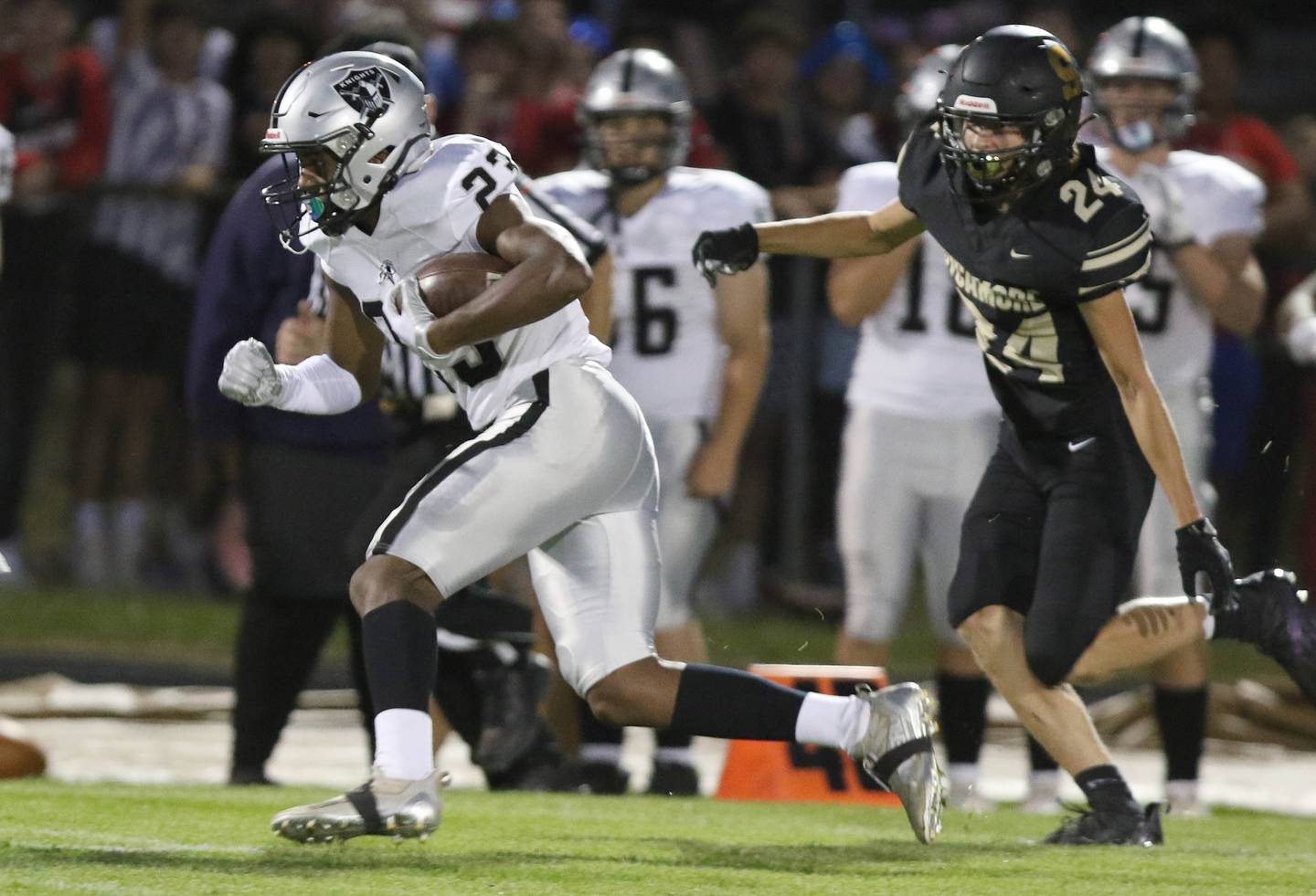 Kaneland's Aric Johnson gets past Sycamore's William Stewart on his way to a touchdown during their game Friday, Sep. 10, 2021 at Sycamore High School.