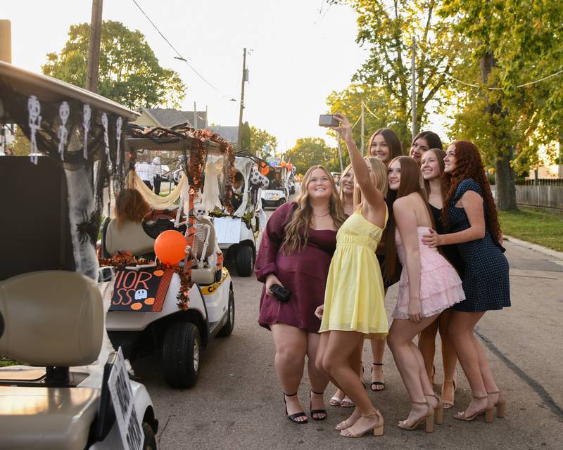 Homecoming candidates pose for a selfie before the start of the Sycamore High School Homecoming parade on Wednesday, Oct. 8, 2025, downtown.