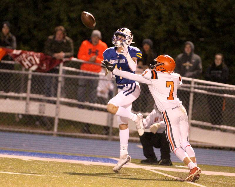 Wheaton Warrenville South’s Colin Jamen (7) breaks up a pass to Wheaton North’s Rich Schilling during a game at Wheaton North on Friday, Oct. 7, 2022.