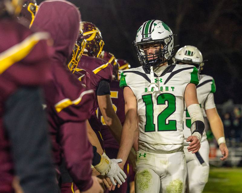 Asher Kargle (12) of Dwight leads team in post game high-five line after loss to Stockton on Saturday, November 15, 2025 at John O' Boyle Field in Stockton.