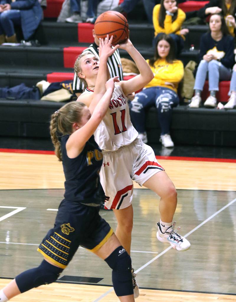 Indian Creek's Madison Bogle scores on a layup in front of Polo's Kadence Sheaffer during their Class 1A regional game Tuesday, Feb. 15, 2022, at Indian Creek High School in Shabbona.