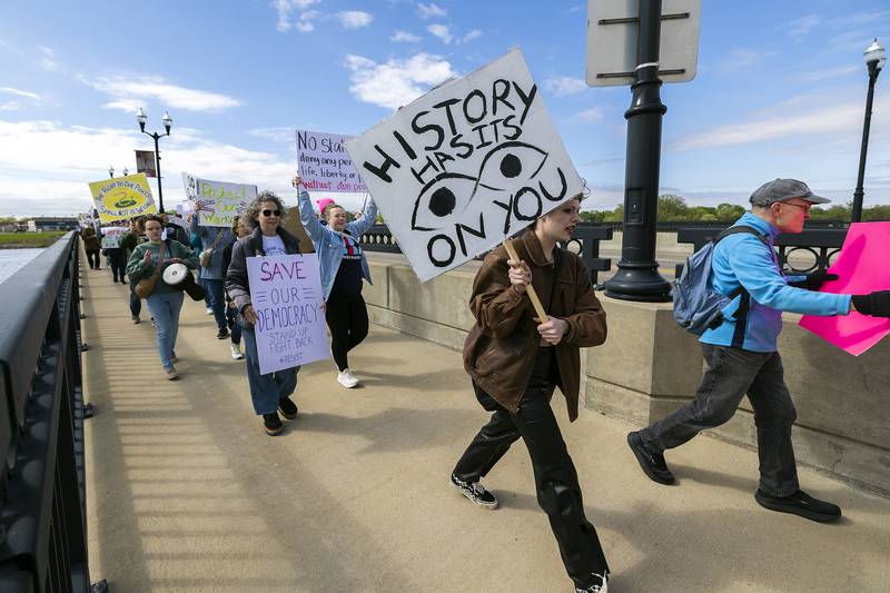 Organized by Indivisible SRFD, a group marches across the First Avenue bridge into Sterling Saturday, May 3, 2025, to protest the Trump administration and show their support for workers’ rights. The crowd started at RB&W Park in Rock Falls and marched to Grandon Civic Center in Sterling.
