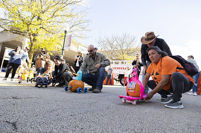 Kristina Maldonado (right) eyes the course for her Barbie themed pumpkin racer Saturday, Oct. 21, 2023 for Scarecrow Fest’s pumpkin derby.