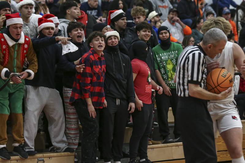 The Oswego student section yells at the referee during their basketball game between Oswego at Yorkville Friday, Dec 12, 2025 in Yorkville.