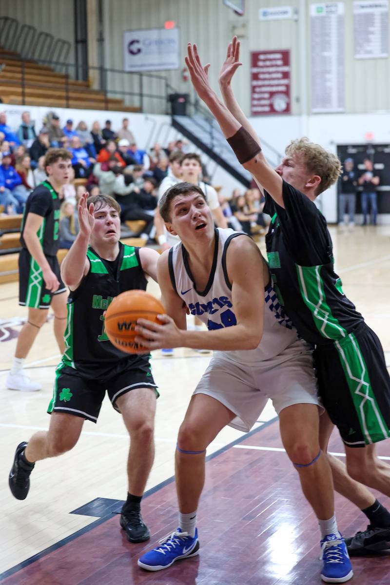 Clifton Central's Conner Unger struggles to shoot under pressure from Bishop McNamara's Richie Darr, right, as Teddy Fogel moves in to strip the ball during the Fightin' Irish's 62-41 victory in the Watseka Holiday Tournament championship on Tuesday, Dec. 16, 2025.