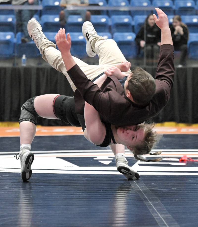 Allison Garbacz, of South Elgin throws her coach Robert Tornabene after winning the 155-pound class at the girls wrestling state finals tournament at Grossinger Arena in Bloomington on Saturday, Feb. 28, 2026.
